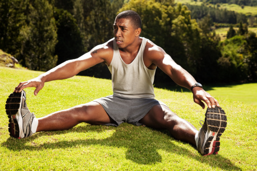 Athlete stretching outdoor.