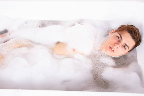 istock Relax and rest. Young attractive guy in the bath. 1575663577