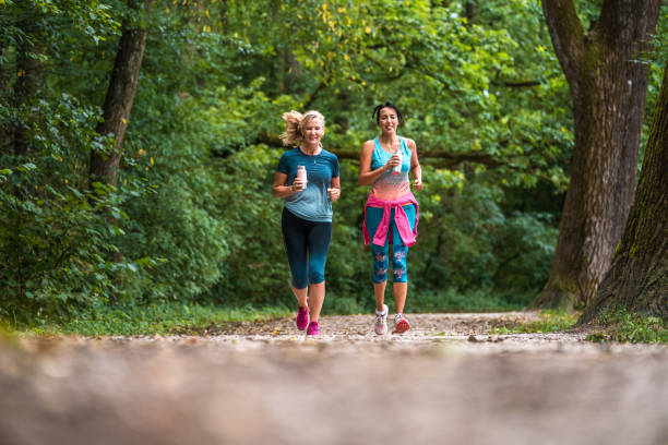 istock Active Mature Diverse Females Running In The Forest 1575667280