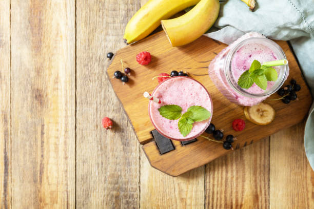 istock Set of fresh various delicious milkshakes or smoothies with fresh berries on a rustic background. Raspberries and black currant. View from above. Copy space. 1575669391