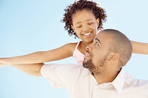 istock Father and girl enjoying a flight against blue sky 157567283