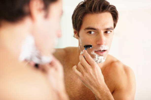 istock Young guy shaving in the bathroom with a razor 157567325