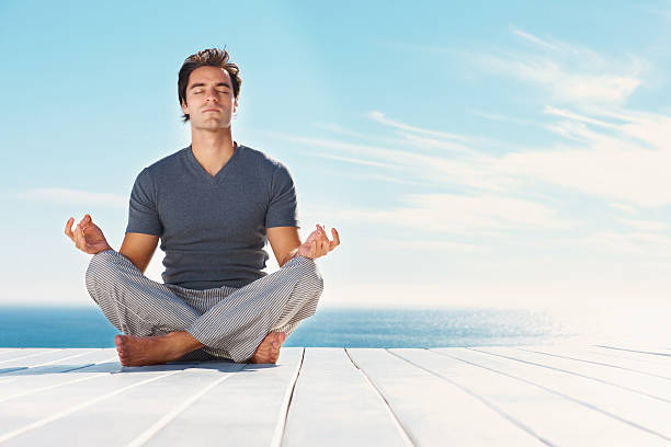 istock Handsome man practicing yoga outdoors 157567327