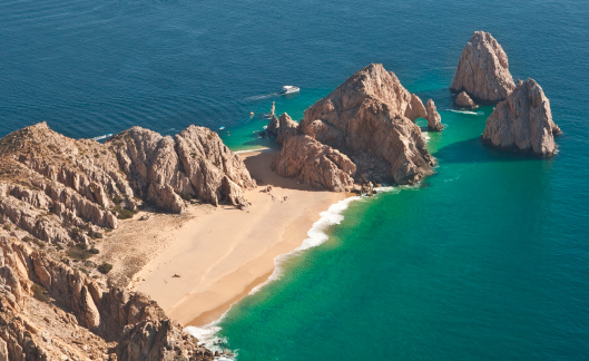Where the Pacific and the Sea of Cortez meet is the famous arch and Land's End.  Cabo San Lucas, Baja, Mexico. Lover's & Divorce Beaches visible.  Shot from ultralight aircraft.