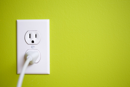 electric plug and socket on isolated white background, front view