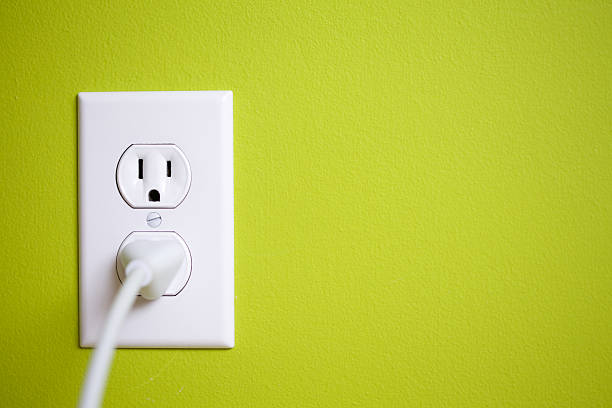 A green wall with a power socket stock photo