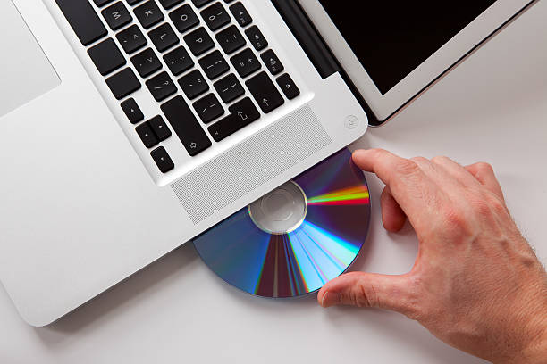 istock Hand Inserting a DVD in the Laptop 157567571