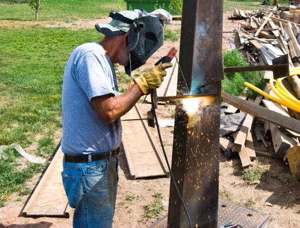 close up welder  welding  steel structure in construction site . welder put on leather gloves and helmet while worker welding protect electric and hot