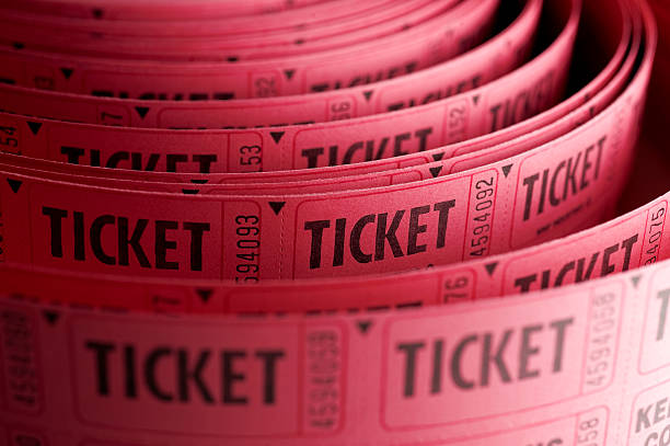 Close up of roll of pink ticket stubs stock photo