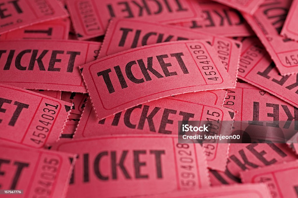 Red raffle tickets scattered and piled up on one another A background of a pile of tickets  Raffle Ticket Stock Photo