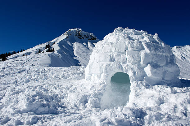 Igloo made of snow near mountain stock photo