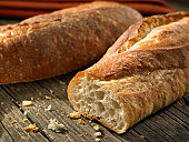 Baguettes with crumbs on weathered background