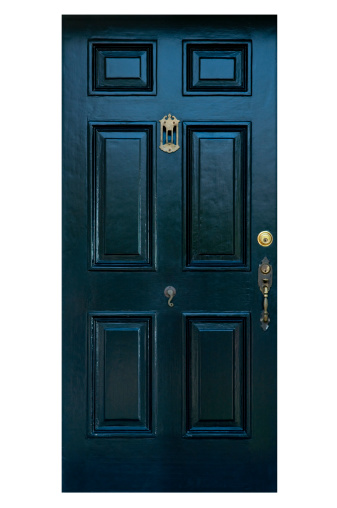 Old black painted six panel front door with clipping path. Antique brass door hardware includes door handle, door bell and peep hole.