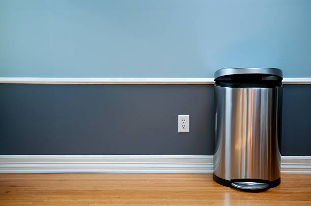 Empty Room With Modern Trash Can Open trash can in empty room with wood flooring, blue wainscoting and a power outlet. garbage bin photos stock pictures, royalty-free photos & images