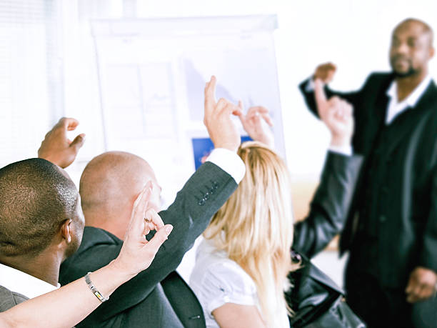 istock Adult students participating and raising hands at a meeting 157568099