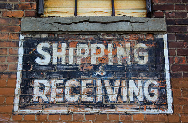 Shipping and Receving Sign Shipping and receiving painted sign on brick wall of run down warehouse/ factory in downtown Detroit detroit ruins stock pictures, royalty-free photos & images