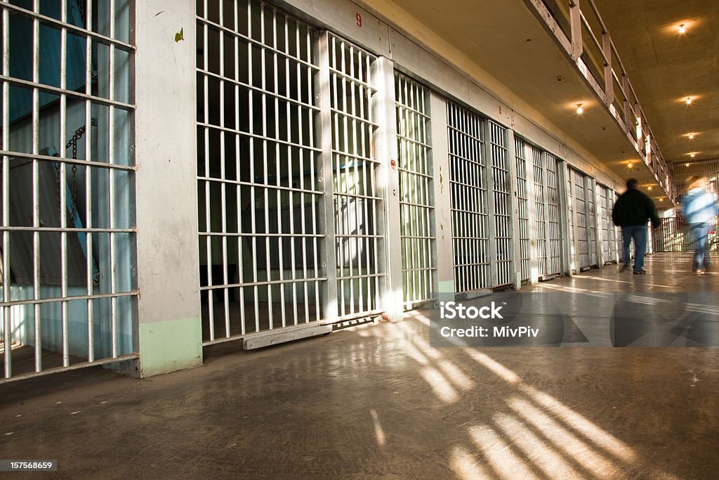 Prison Inside The Old Idaho State Penitentiary - two people walking away from the camera with intentional motion blur. Prison Stock Photo