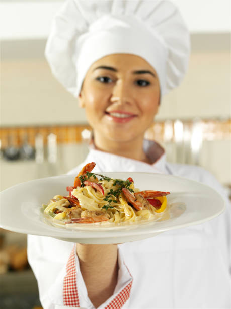 istock Female chef holding food plate 157568699
