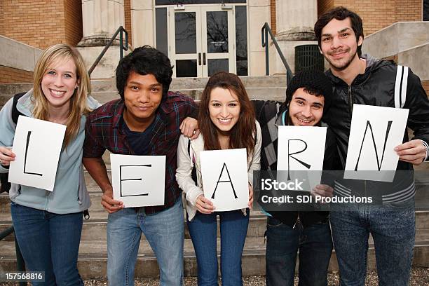 Young Group Holding Learn Sign To Signify Importance Of Education Stock Photo - Download Image Now