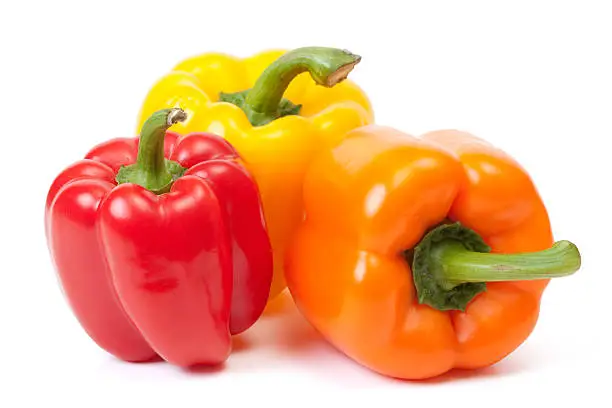 Photo of Three bell peppers, a red, a yellow and an orange one