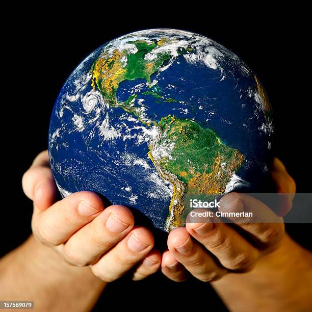 A Picture Of Someone Holding A Mini World In Their Hands Stock Photo - Download Image Now