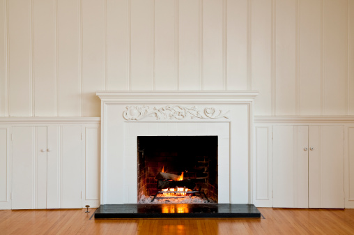 A beautiful view of a fire burning in a wood-burning fireplace in a home
