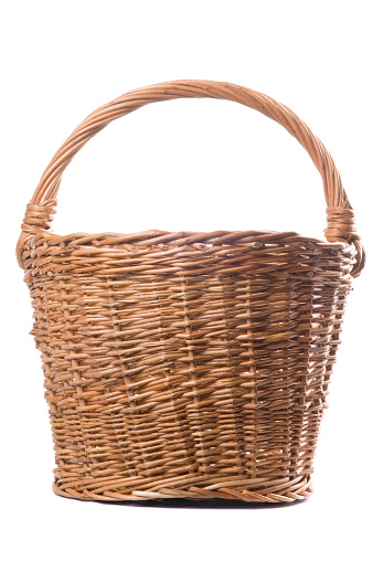 Traditional craftsman made brown wicker basket isolated on a white background. Studio shot.