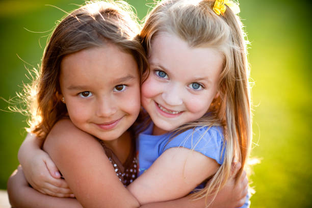 istock Two Happy Friends Hugging Each Other Outside 157569132