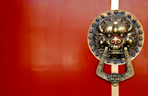 Asian Lion Door Knocker on Red Background