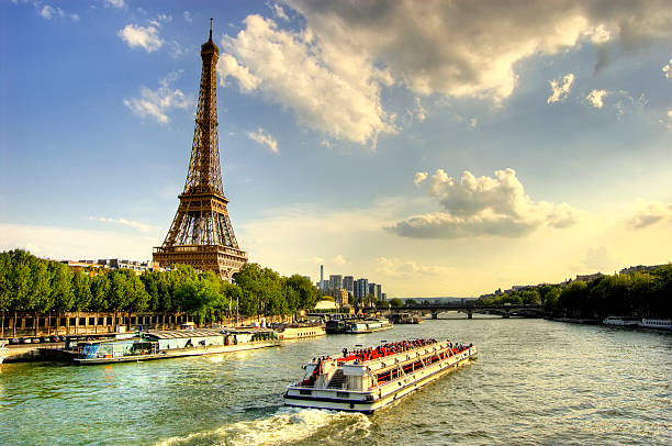 Eiffel Tower and Quay Seine River Eiffel tower and quay Seine river with barges and trees at sunset. barge stock pictures, royalty-free photos & images