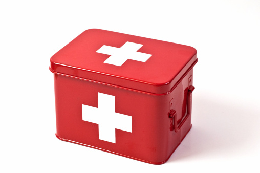 A red metal first aid box on white background