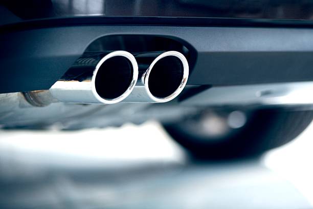 Stainless steel exhaust pipes on a blue car exhaust vapor trail photos stock pictures, royalty-free photos & images