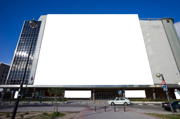 Mock up white vertical large LED display billboard on tower building with cityscape background .Clipping path for mockup