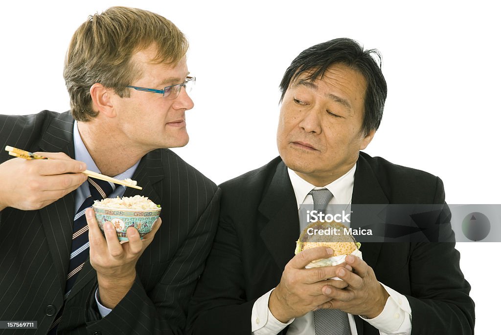 Cultural exchange Two partners eating each one the other's cultural food. Eating Stock Photo