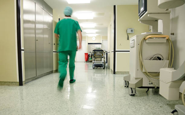 istock Surgeon hurrying along a hospital floor 157569713