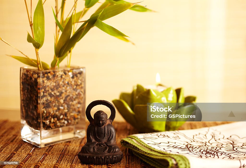 Home decor still life of bamboo in vase  and buddha Home decor still life of bamboo in vase with lotus leaf candle and buddha statue Feng Shui Stock Photo