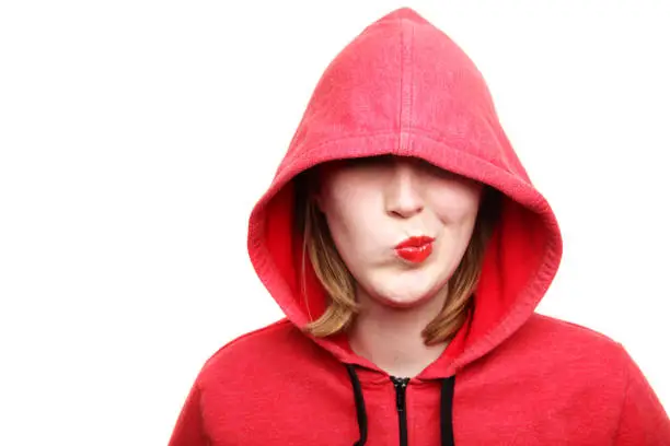 Woman wearing red hooded top - covering eyes