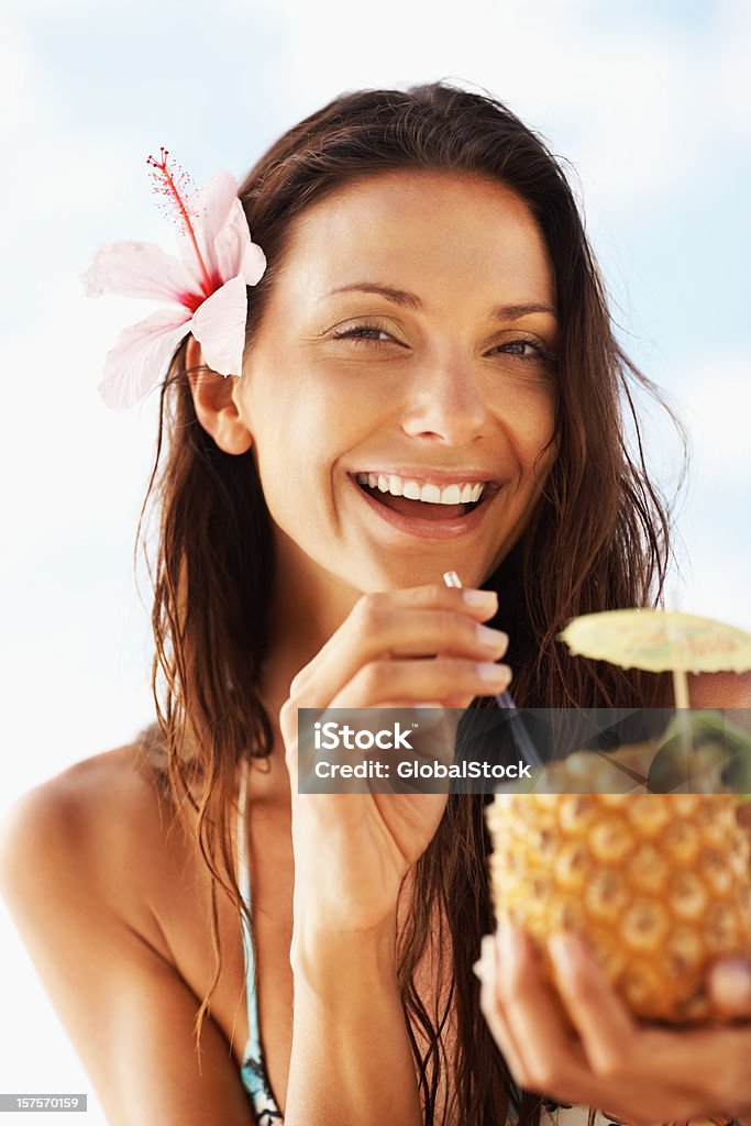 Happy woman drinking pineapple juice  25-29 Years Stock Photo