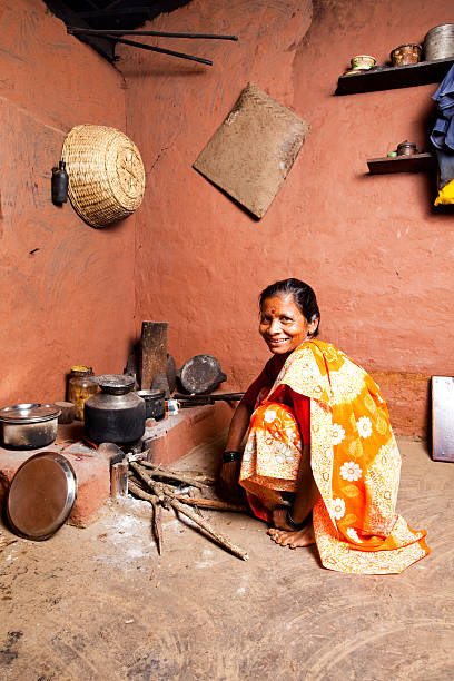 One Cheerful Traditional Rural Indian Woman preparing food  village maharashtra stock pictures, royalty-free photos & images