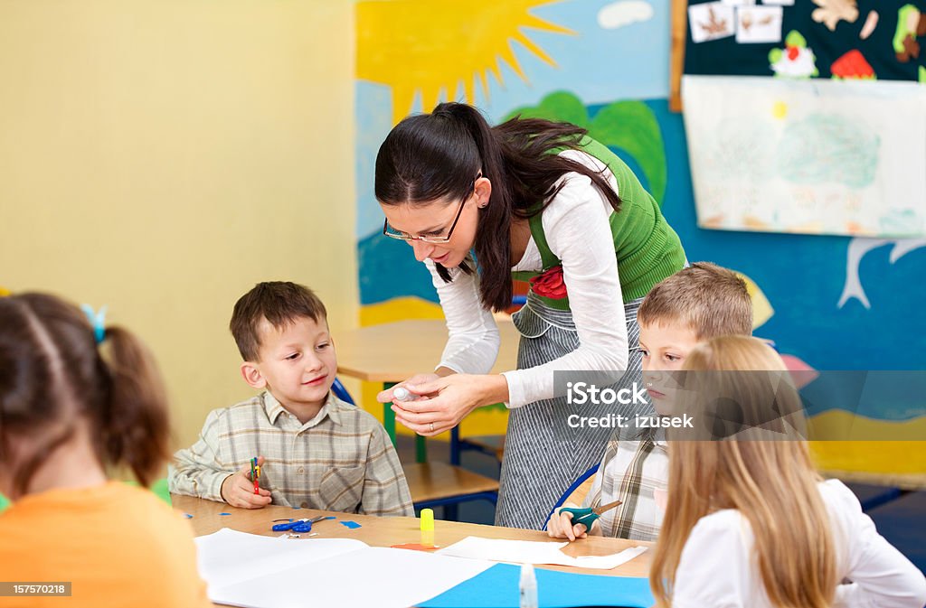 Teacher Helping Pupils With Artwork  6-7 Years Stock Photo