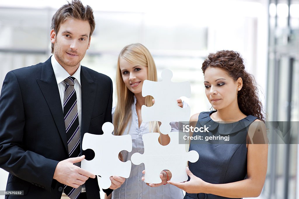 Tre uomini d'affari con puzzle - Foto stock royalty-free di Lavoro di squadra