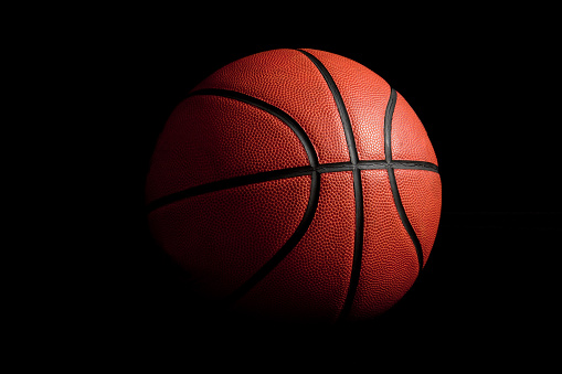 side view of the curves of a basketball ball in a three-dimensional rendered image with a black background