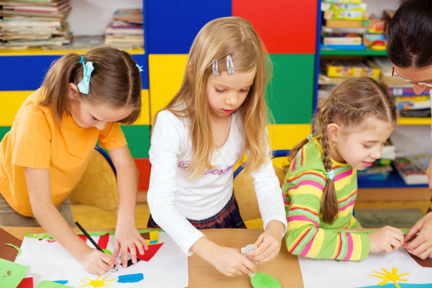 istock Little Girl Creating Collages In Class 157570602