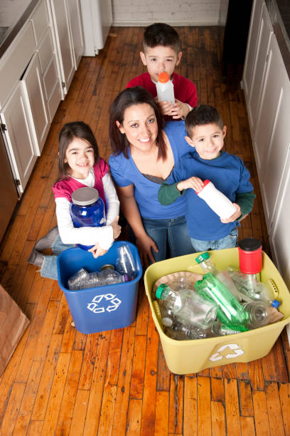istock Go Green: Hispanic Family Recycling Together 157571011
