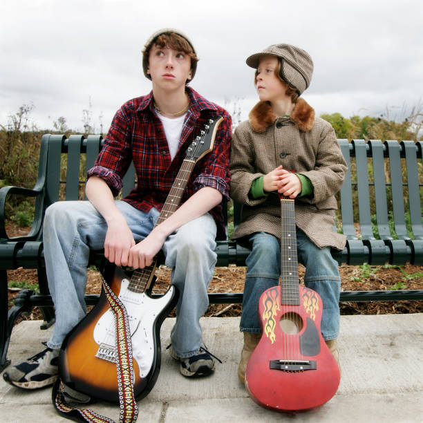 niños con guitars sentado en el banco - parker brothers fotografías e imágenes de stock