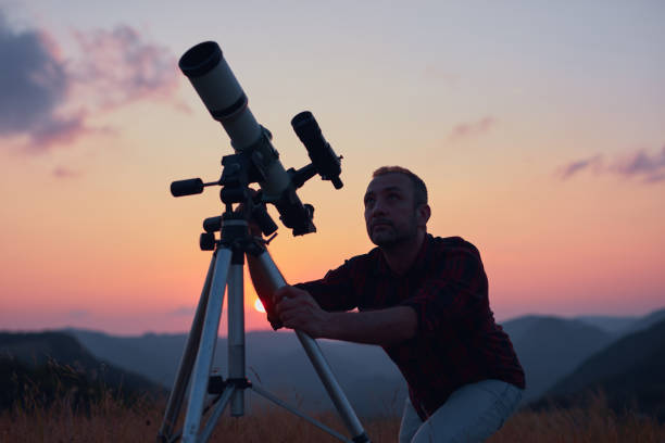 istock Astronomer looking at the skies with a telescope. 1575711814