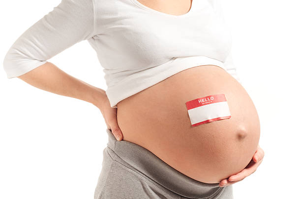 istock Pregnant Woman with Name Tag on Bare Belly 157571226