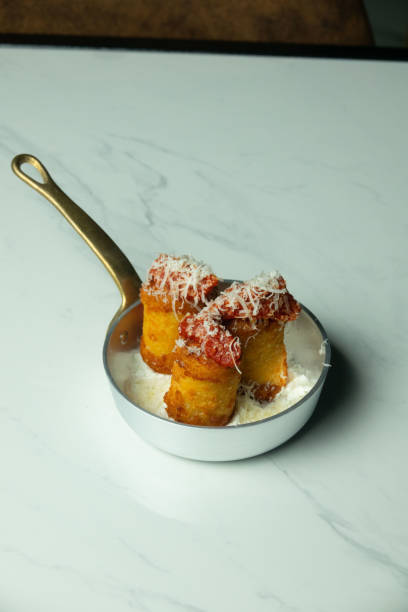 istock Small pan with pasta and tomato on a marble table 1575716737