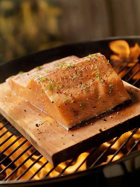 istock Raw Cedar Plank Salmon Fillets on an outdoor BBQ 157571900