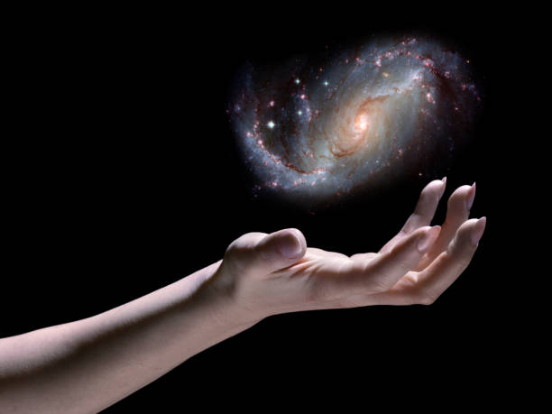 Astronomer; Spiral Galaxy in Hand, Black Background, Science Fiction, God Astronomer; Galaxy in Hand. This image is meant to be inspirational, a visual metaphor for the power of scientific study of the Universe. spiral galaxy stock pictures, royalty-free photos & images